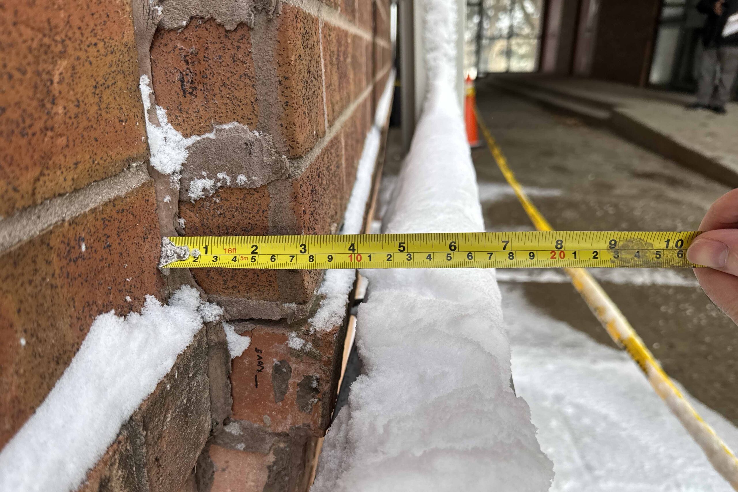Measurement of brick veneer displacement showing approximately 3 inch outward bulge