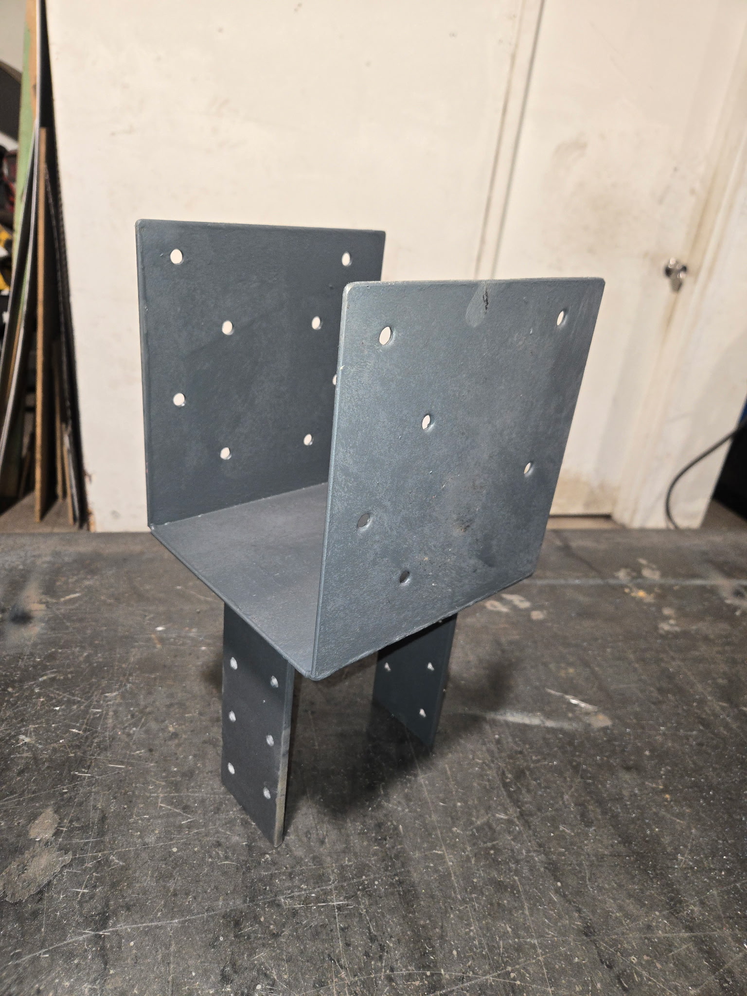 Custom fabricated steel beam-to-post bracket with side plates and base support